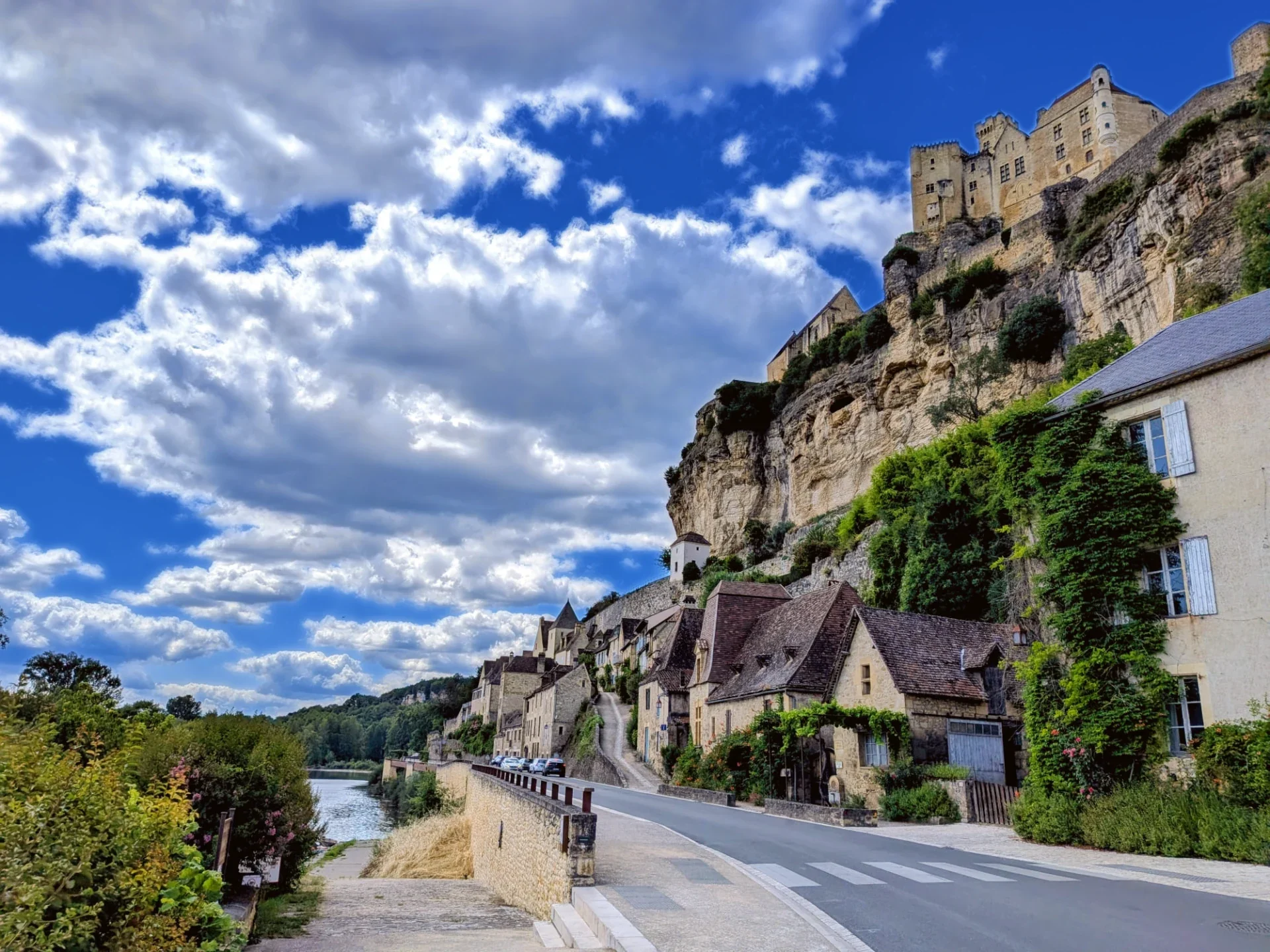 The Dordogne and the riverside road at Beynac, with the village and château rising above