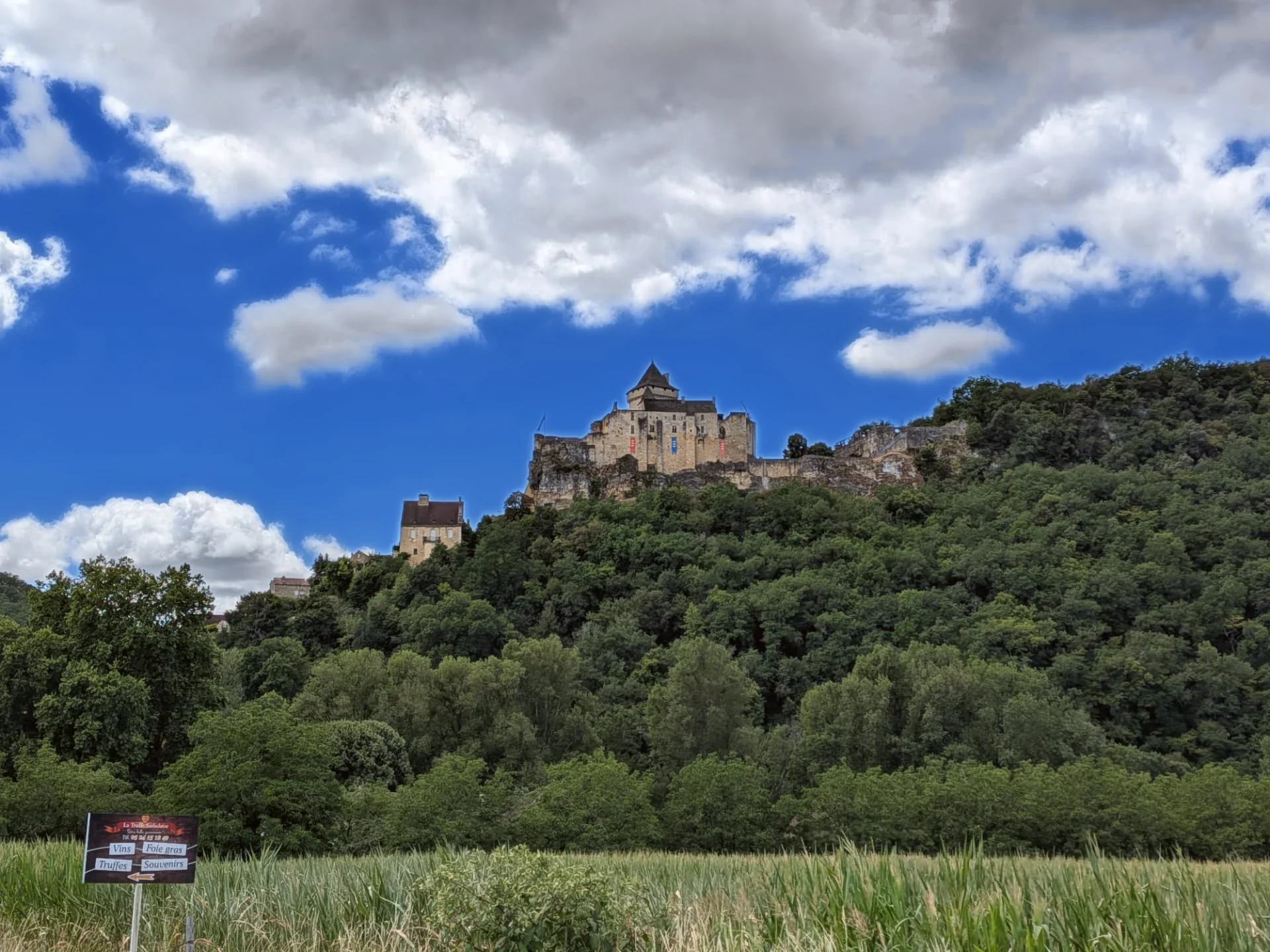 Château de Castelnaud on its limestone cliff, seen across the valley fields