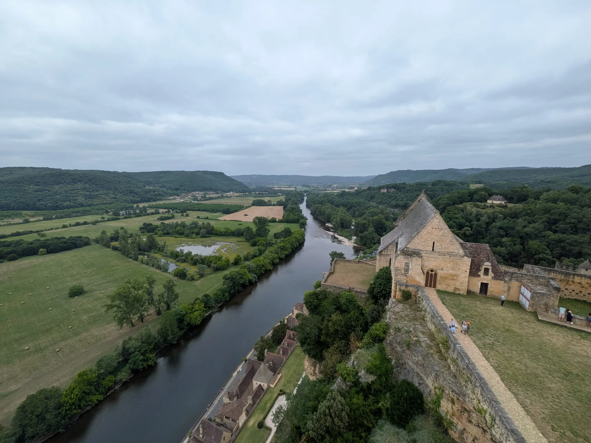 View from the ramparts of Château de Beynac over the village roofs and the Dordogne valley