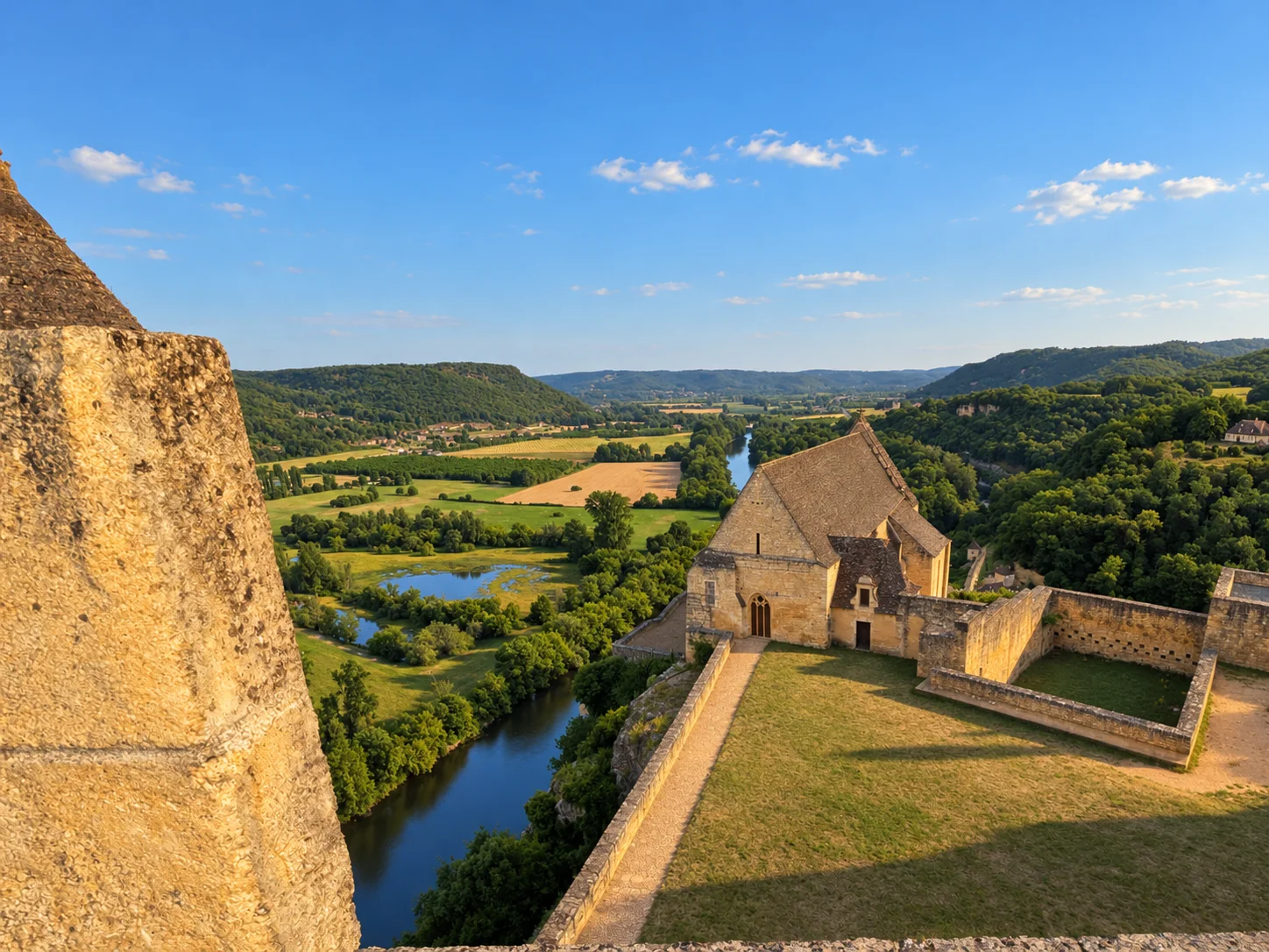 View from a stone embrasure at Château de Beynac over the inner courtyard and the river valley