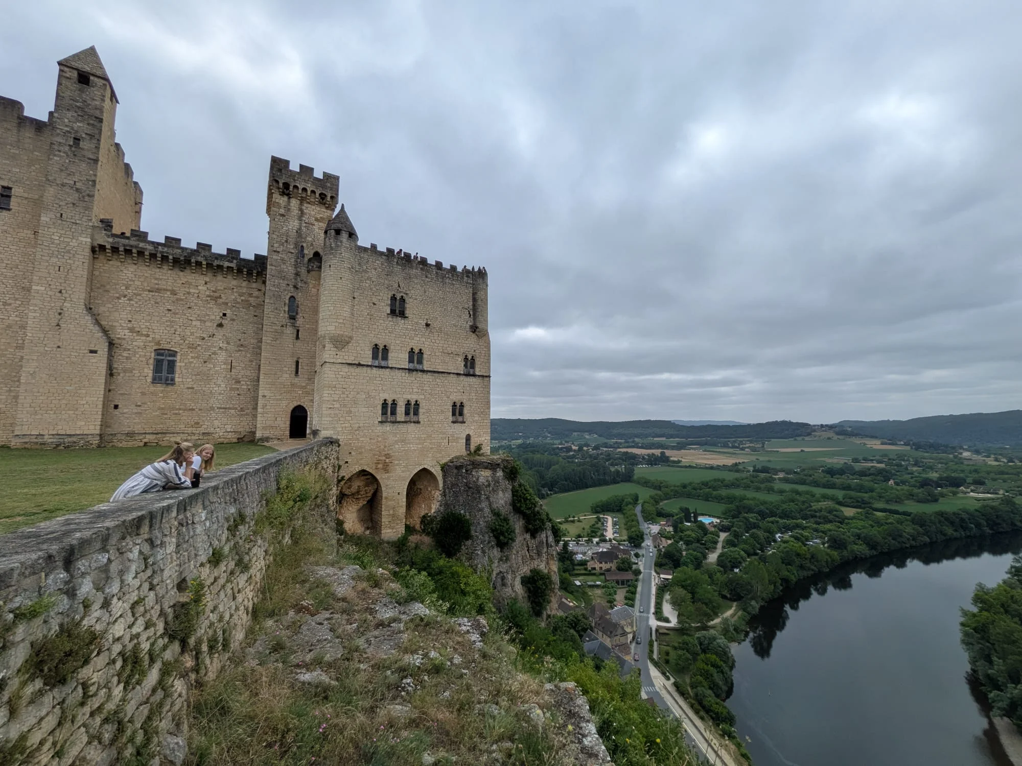 Château de Beynac on its cliff above a bend in the Dordogne under an overcast sky